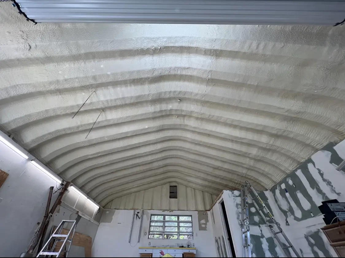 Spray polyurethane foam applied to the underside of a metal roof deck in Bright